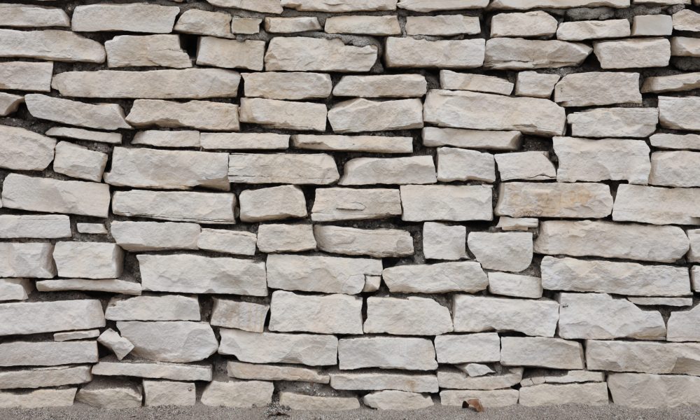 Texture of a stone wall background. Part of a stone fortress or castle fencing for background